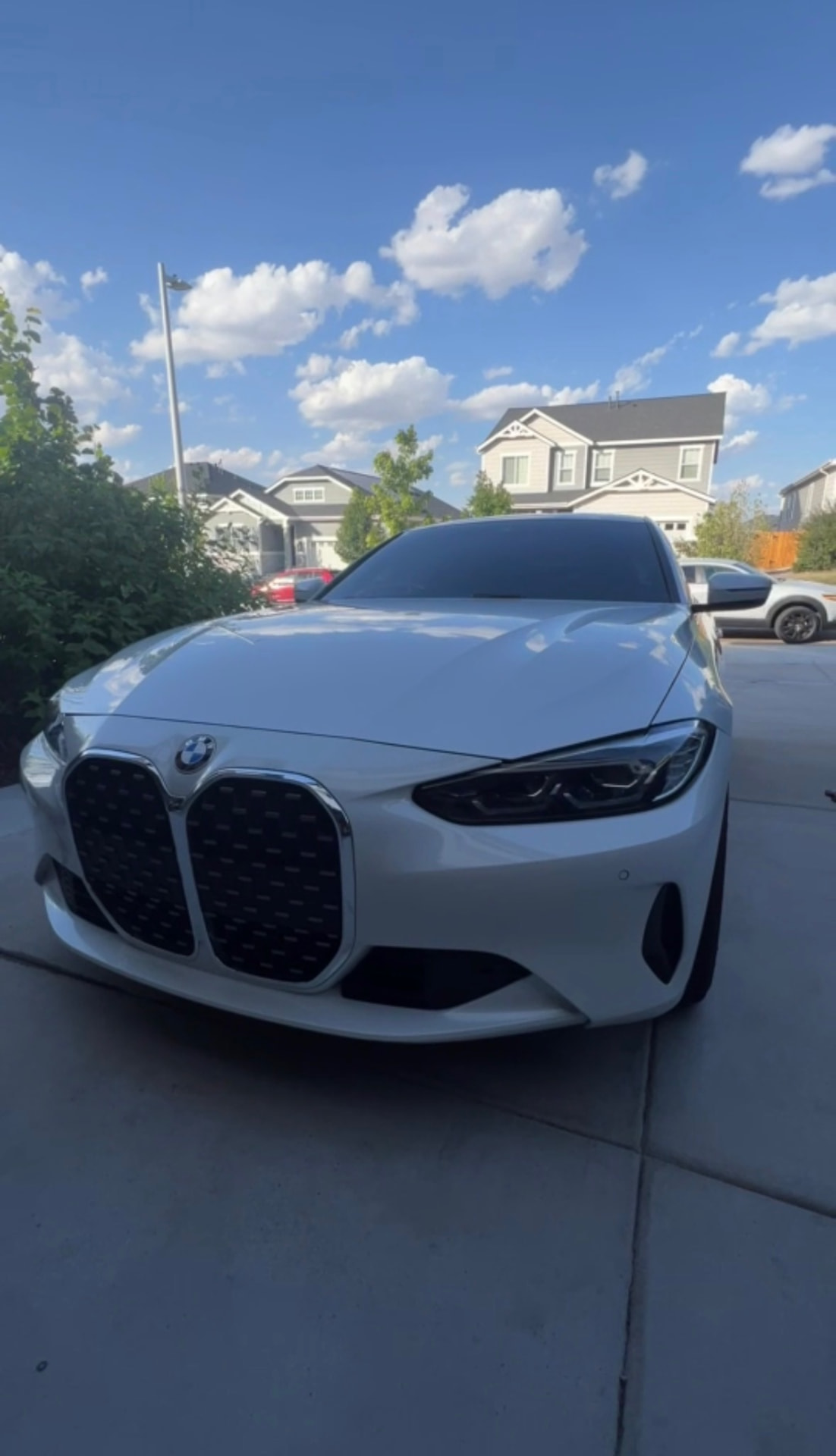 White BMW 4 Series detailed by Rocky Mountain Mobile Detailing in an Aurora CO driveway
