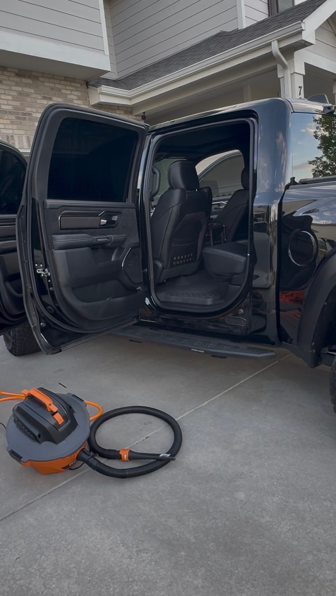 Black pickup truck interior being detailed in a Colorado driveway